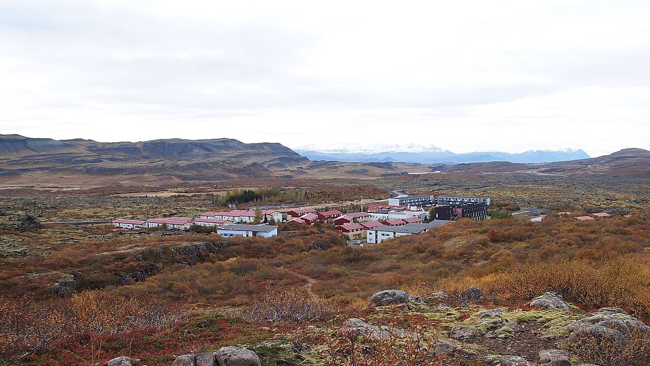Bifröst University buildings in an autumn lava landscape with mountains in the distance